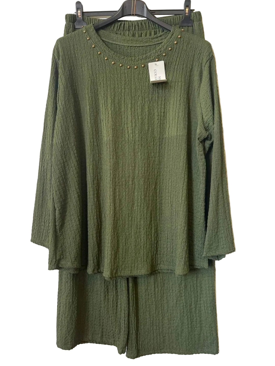 An olive green two-piece set consisting of a textured long-sleeve top with gold stud detailing around the neckline and matching textured pants,
