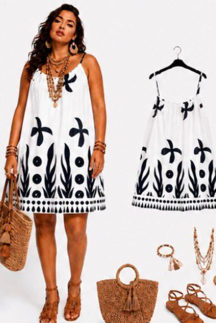 Woman wearing a white dress with black patterns,