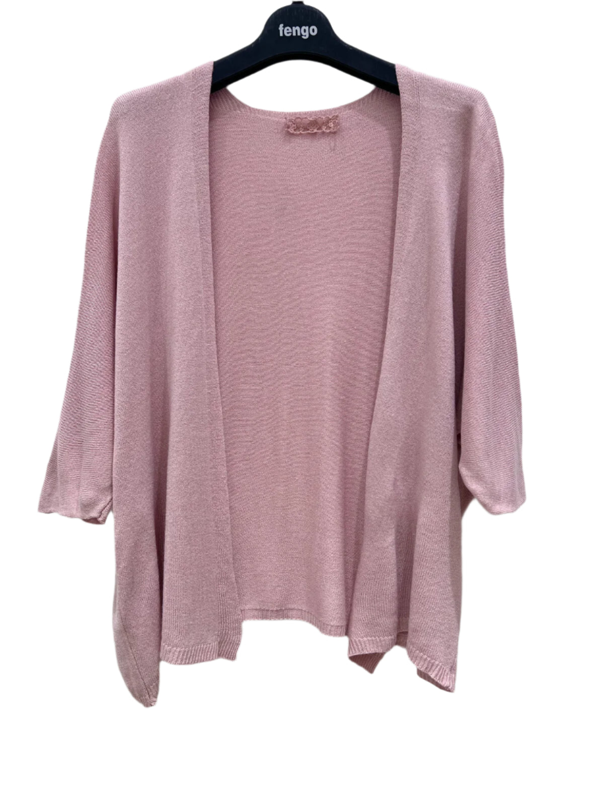 Pink cardigan on a hanger against a white background