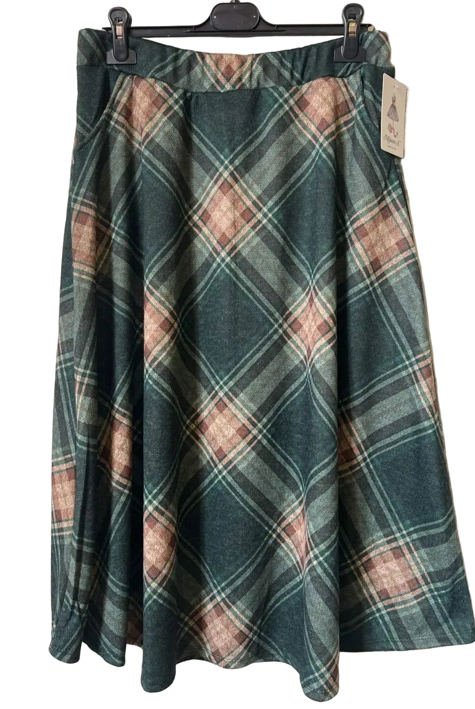 A plaid A-line skirt in dark green, dusty pink, and beige,