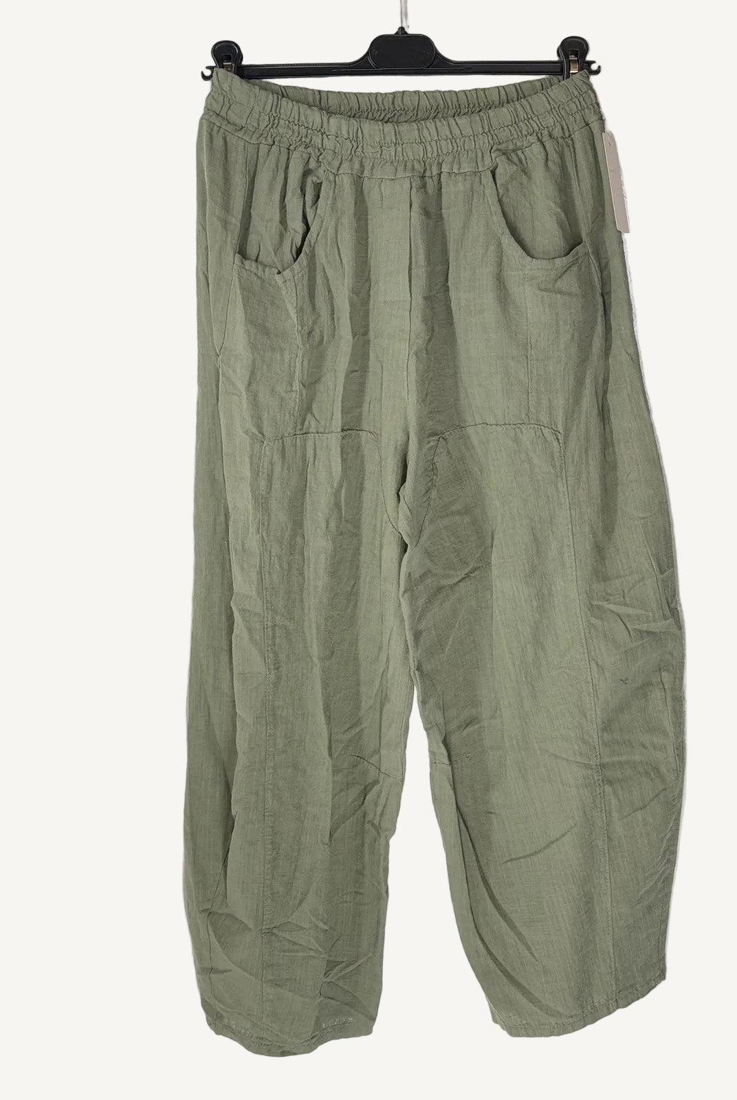 Green pants on a hanger against a white background