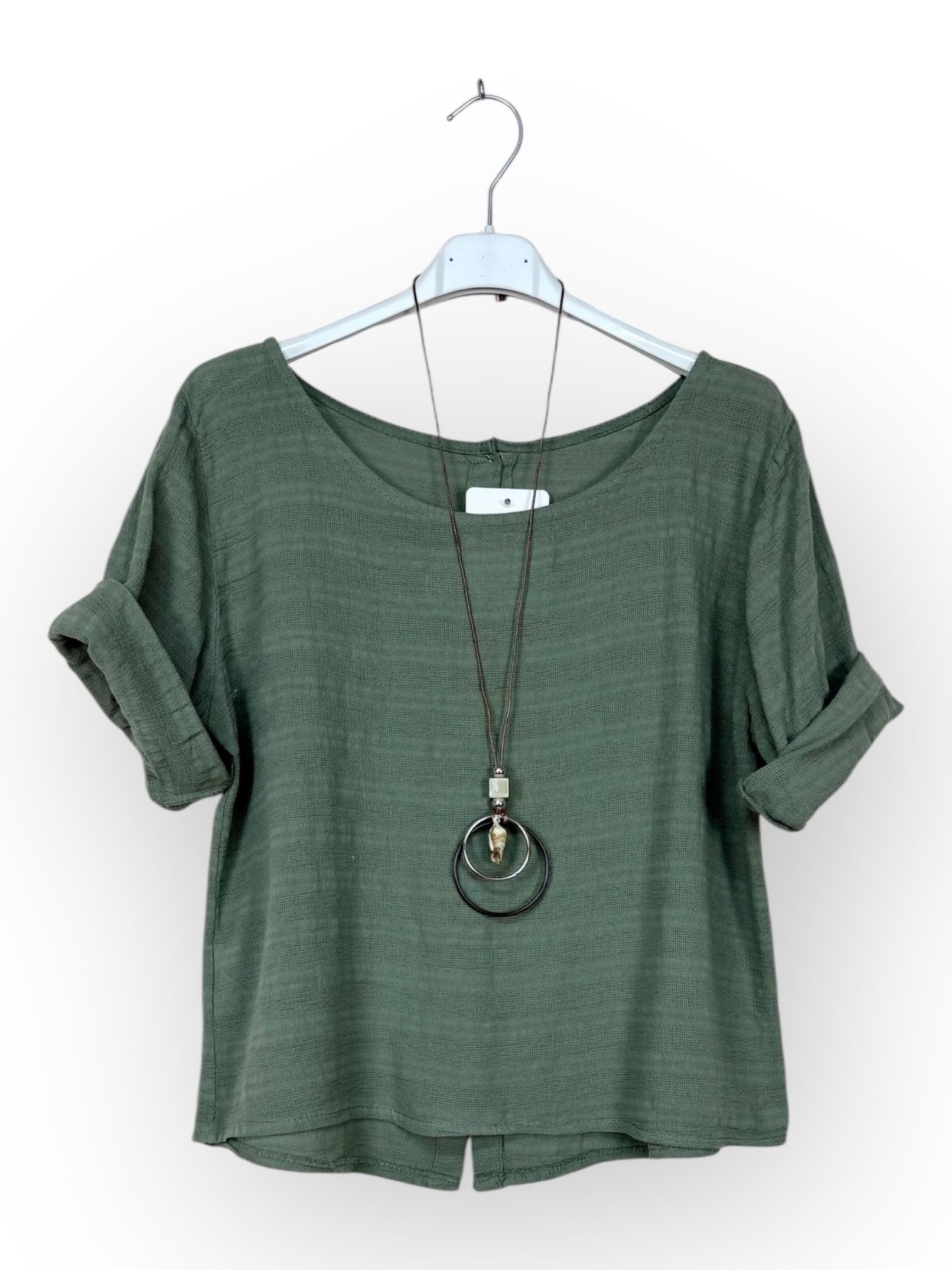 Green top on a hanger with a necklace