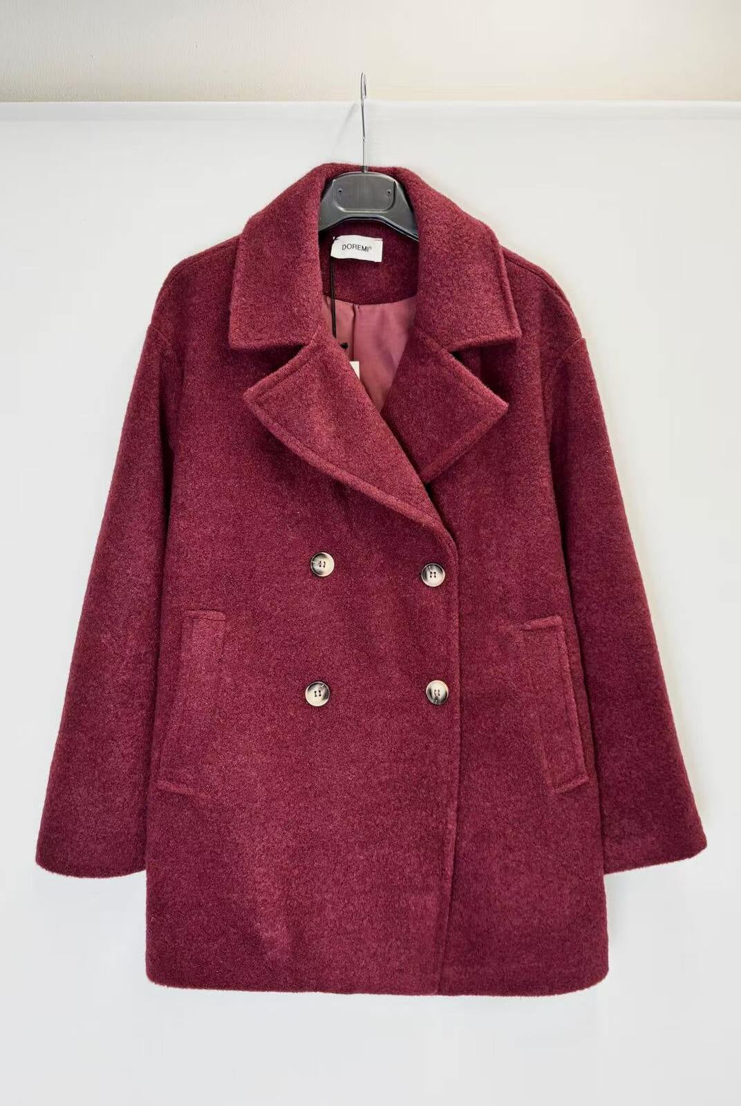 A double-breasted wool-blend coat in a deep burgundy