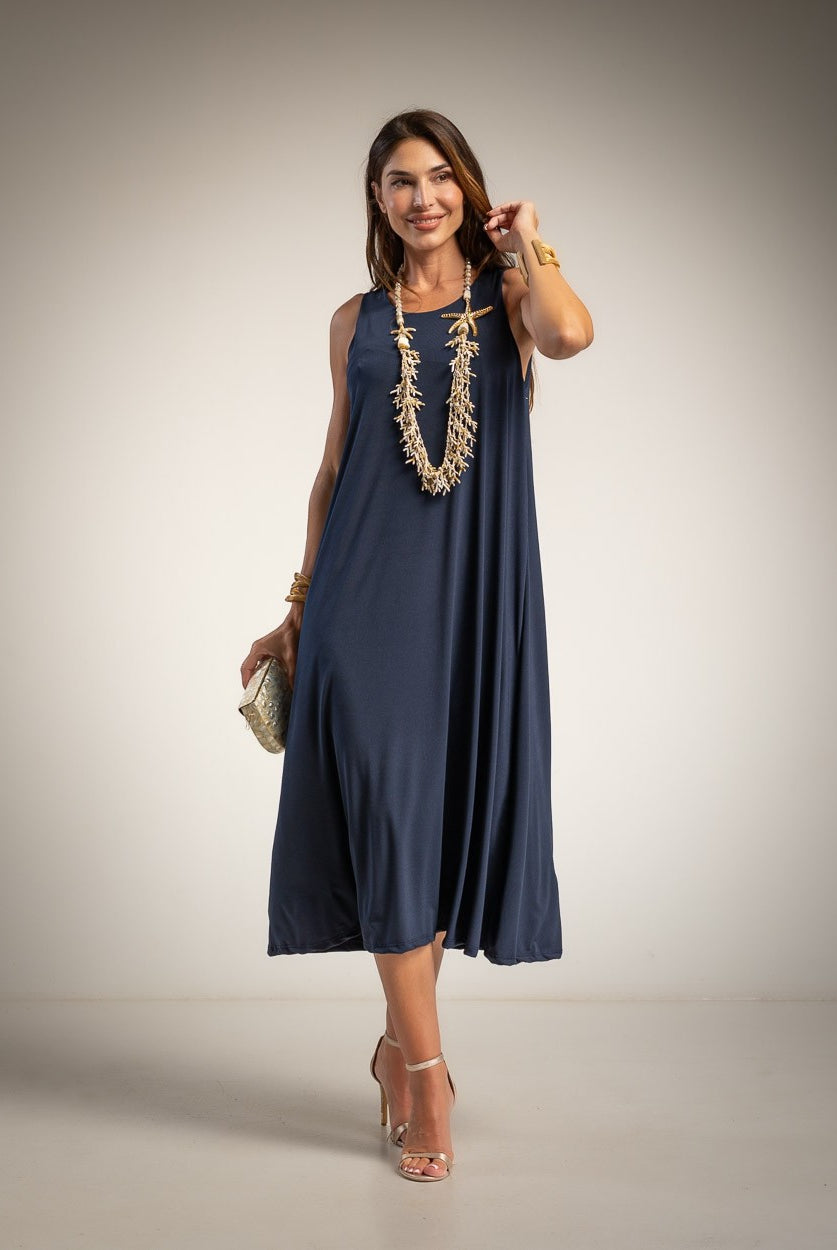 A woman modeling a sleeveless navy blue midi dress with a flowing silhouette.