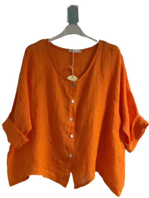 A orange one size pure linen button fronted collarless shirt with three quarter sleeves.