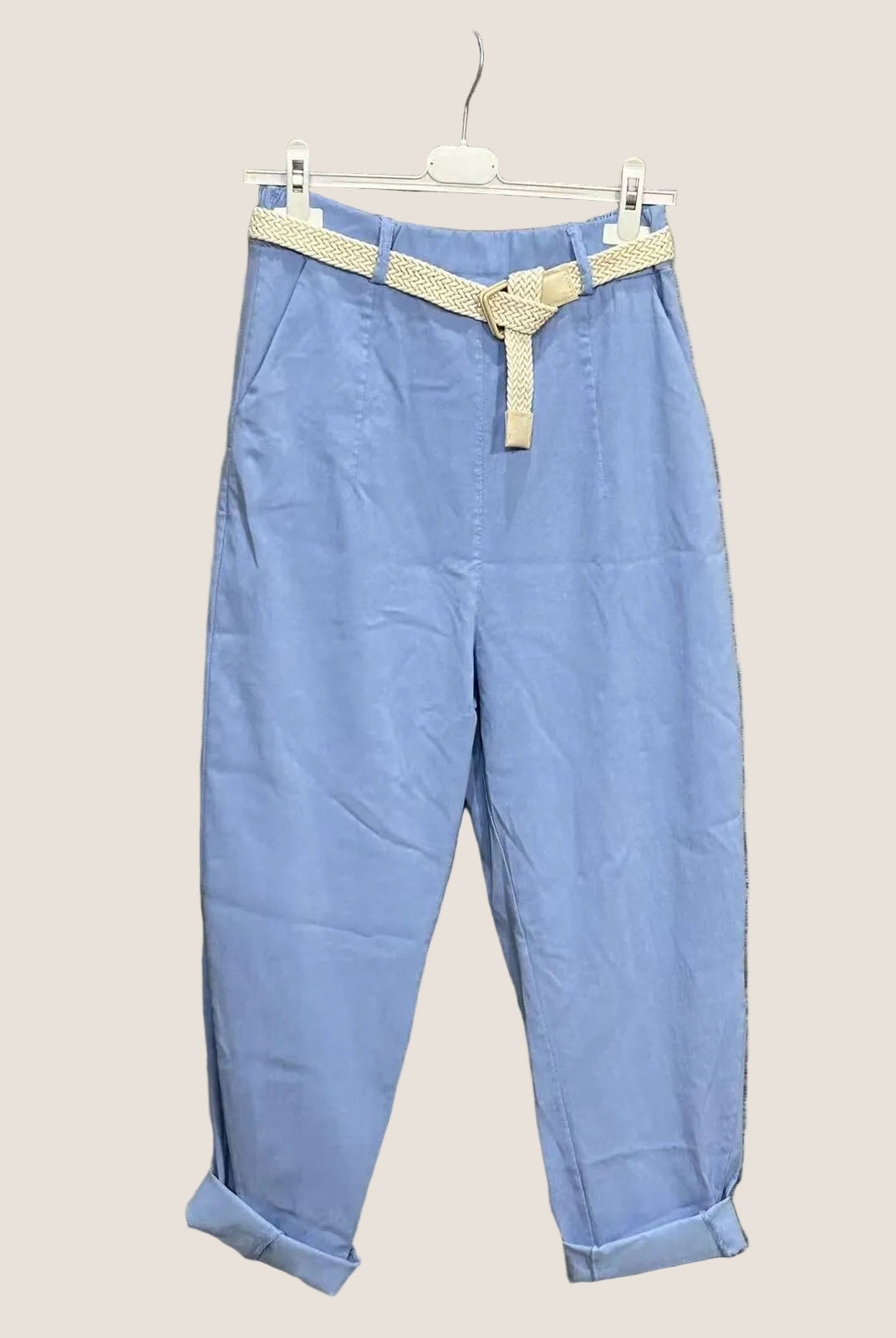 Light blue pants with a beige belt.