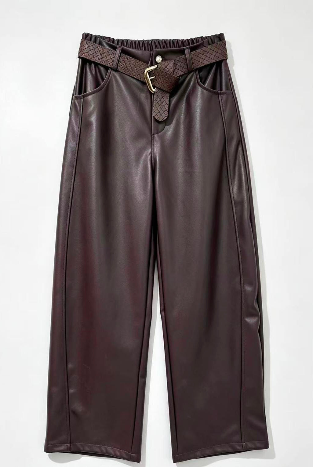 Burgundy faux leather wide-leg pants with a matching woven belt featuring a gold buckle, displayed flat against a light gray background.