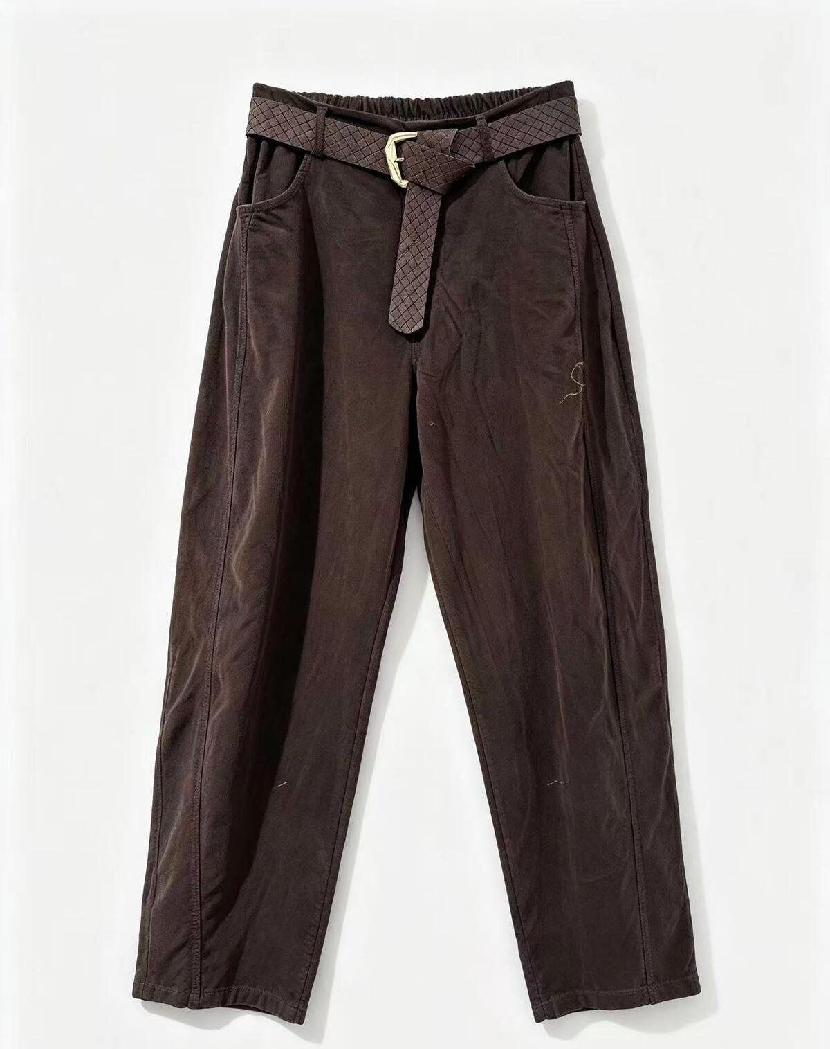 Dark brown wide-leg trousers with a matching patterned belt and gold-tone buckle, laid flat against a white background.