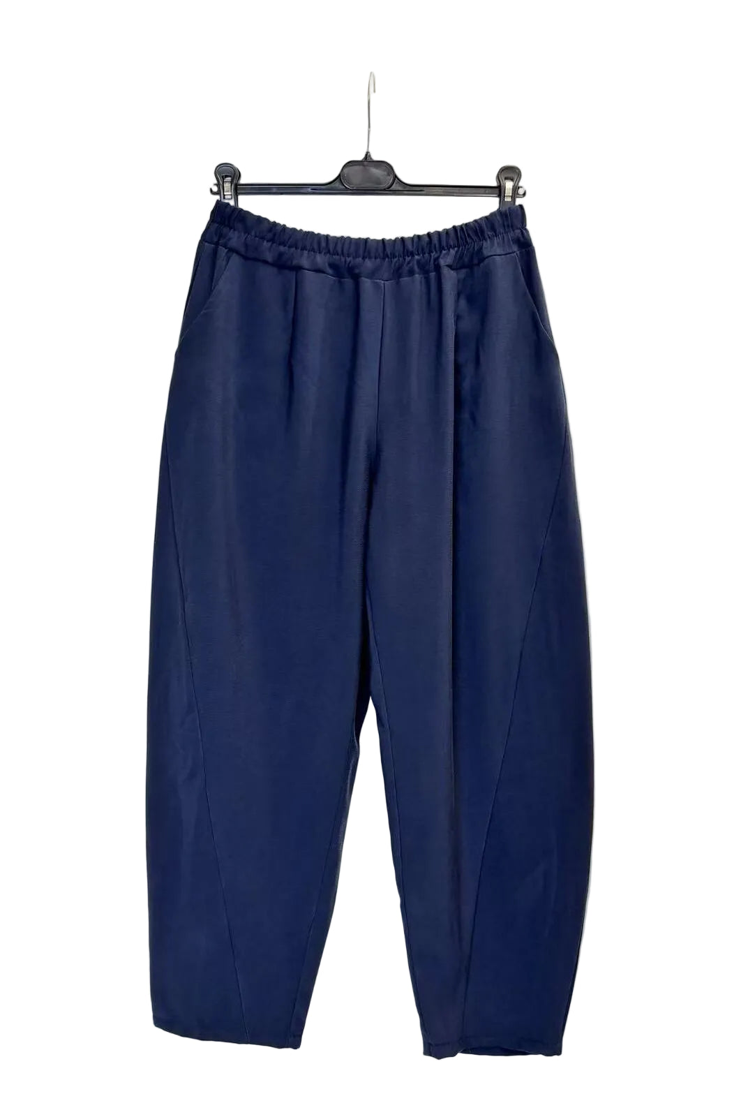 A pair of navy blue cropped pants with an elastic waistband, hanging from a black hanger against a plain white backdrop.