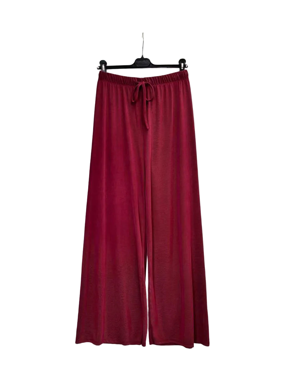 A pair of wide-leg knit pants in a deep burgundy red