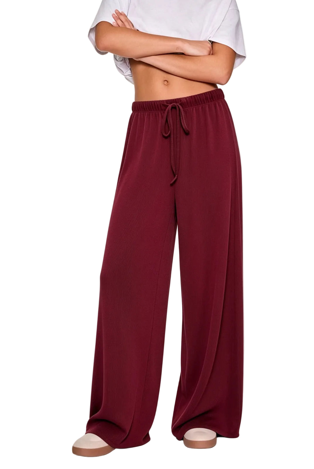 A model wearing wide-leg burgundy drawstring pants.