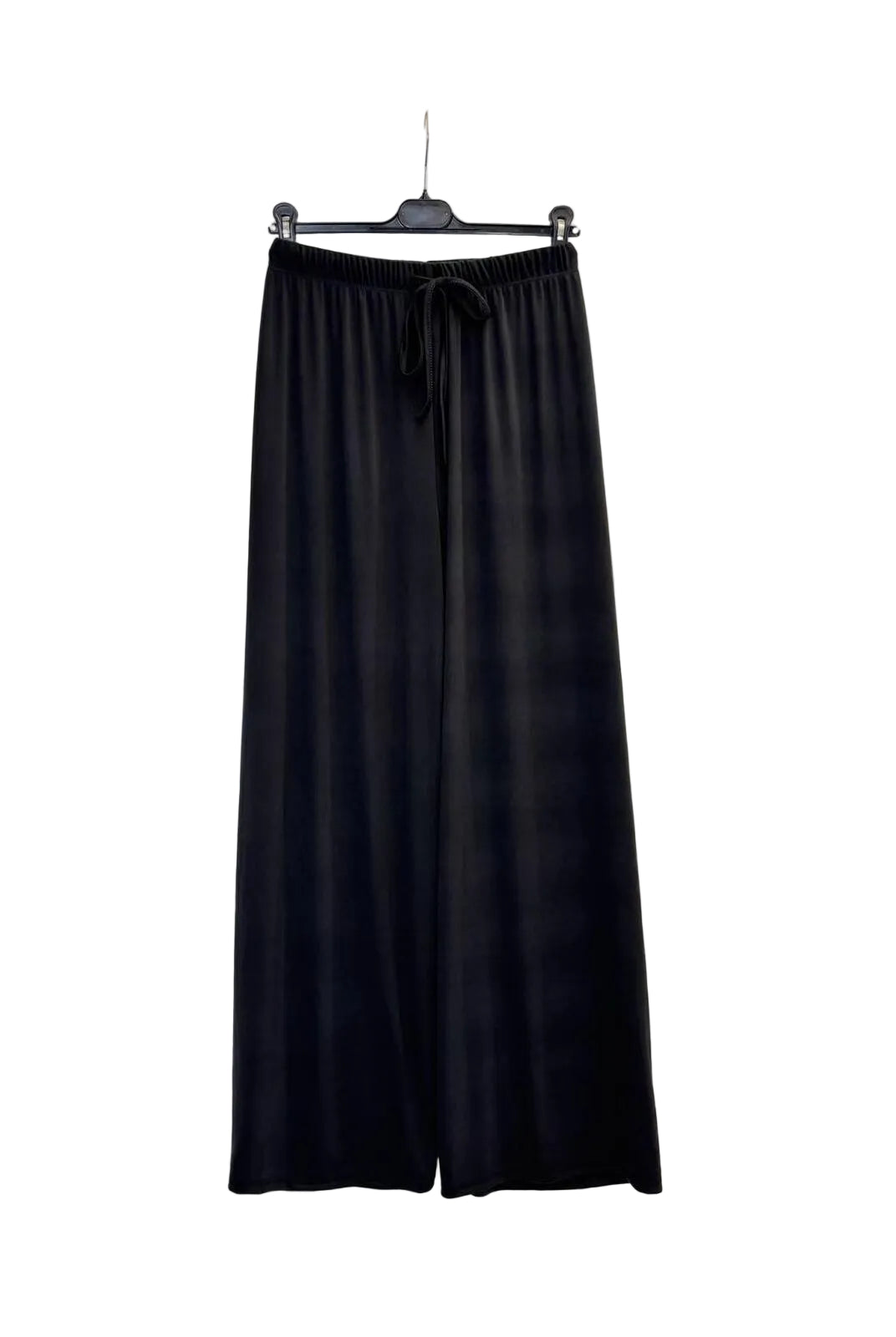 Black wide-leg lounge pants with an elastic drawstring waist, hanging on a black hanger against a plain white wall.