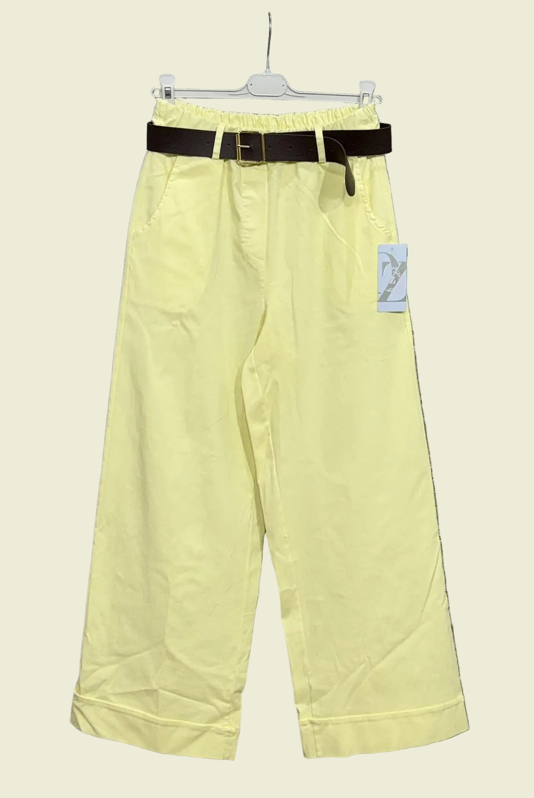 Light yellow pants with a black belt