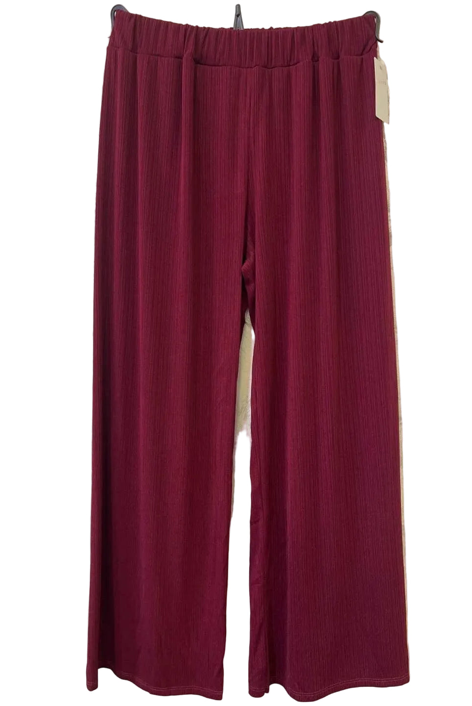 A pair of wide-leg trousers in a deep burgundy colour