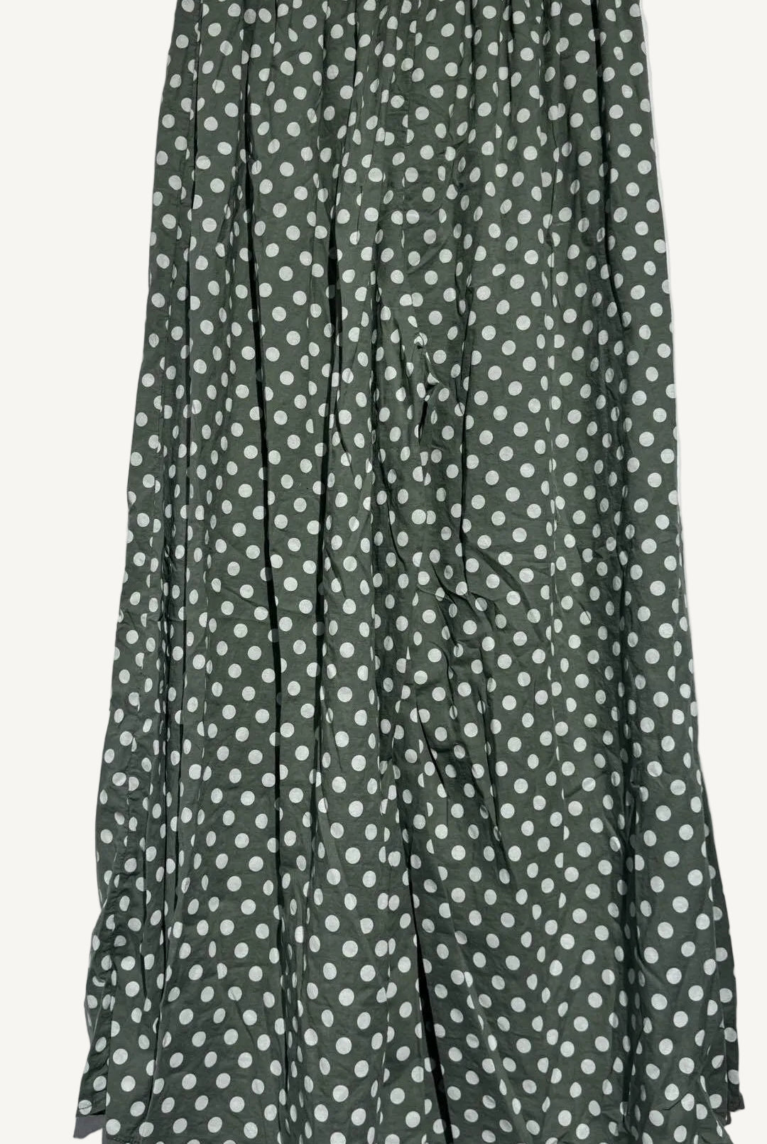 Green pants with white polka dots on a white background