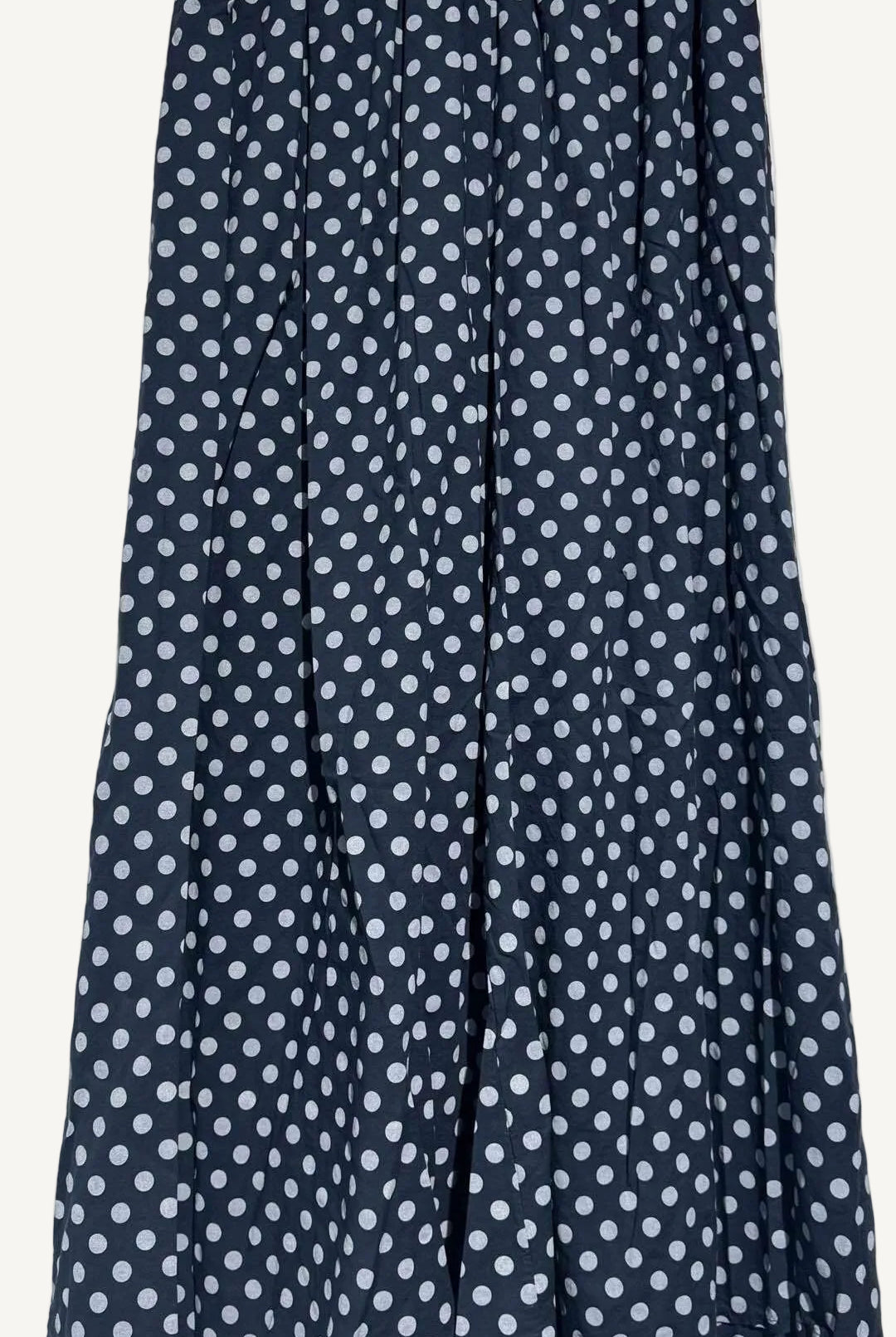Navy blue pants with white polka dot pattern on a white background