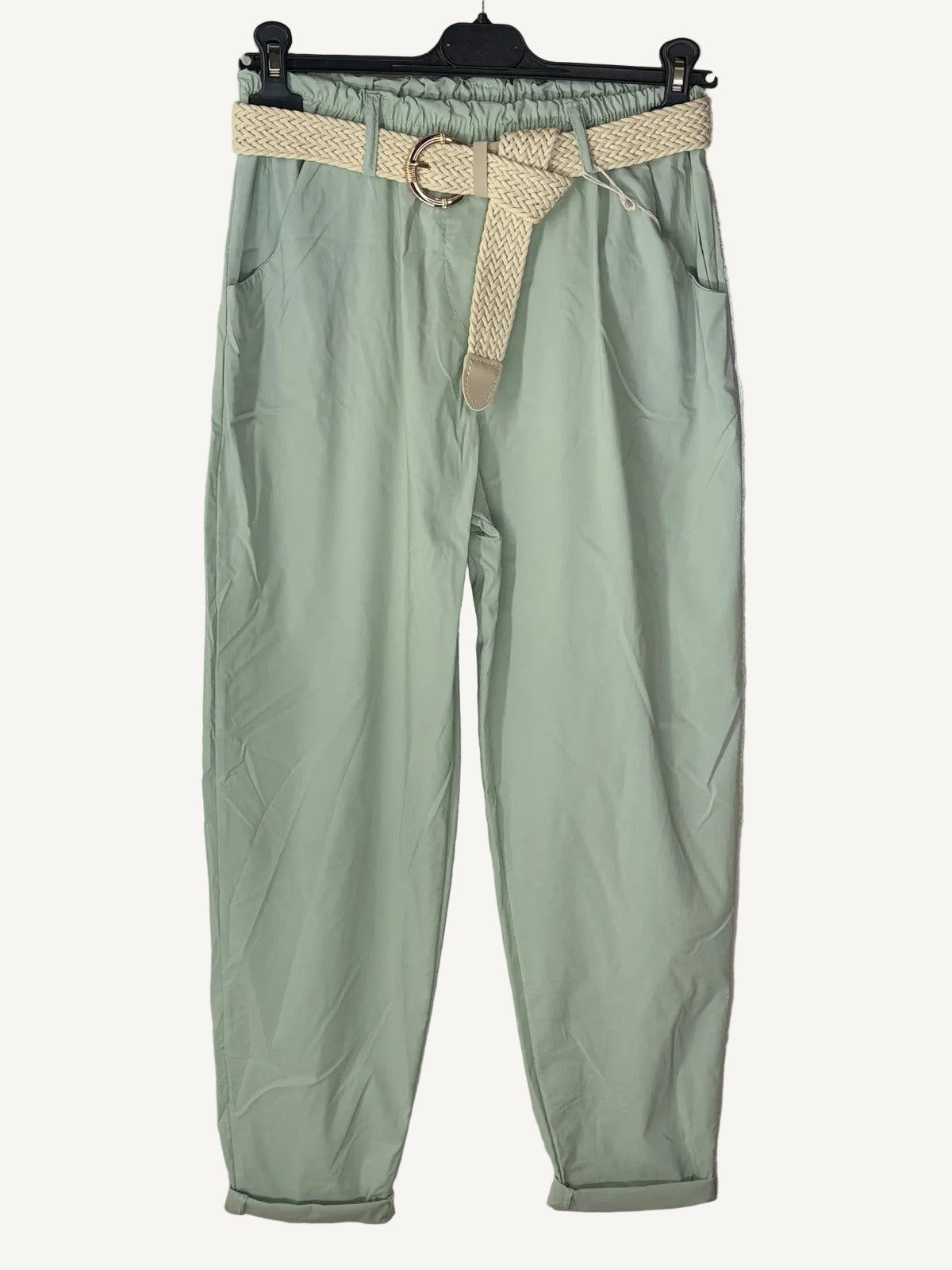 Green pants with a belt on a hanger