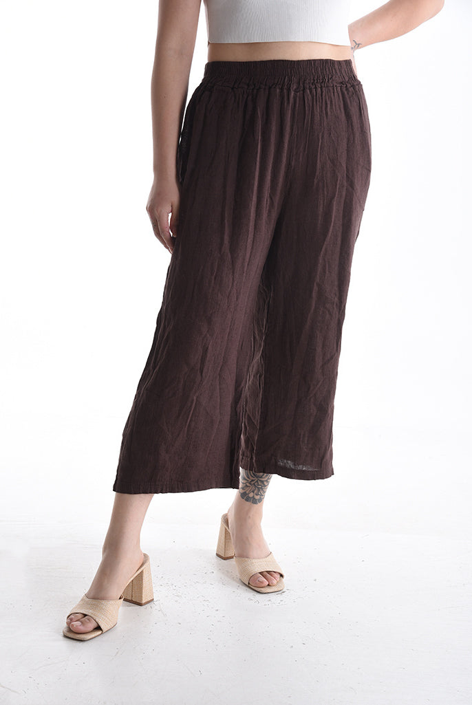 Brown wide-leg pants worn by a person on a white background
