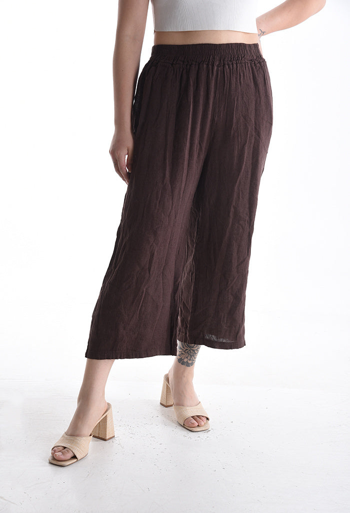 Brown wide-leg pants worn by a person on a white background