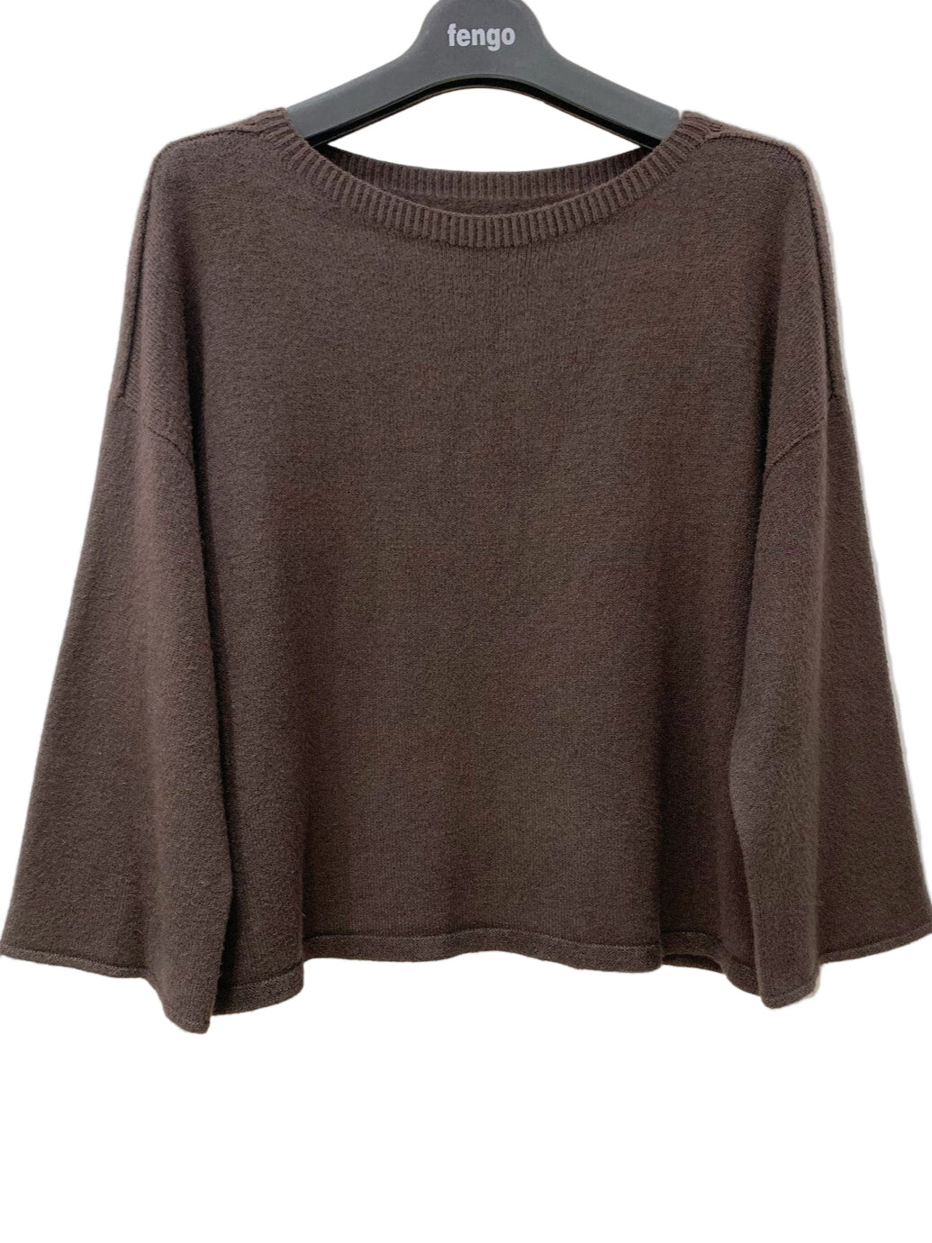 Brown sweater on a hanger against a white background