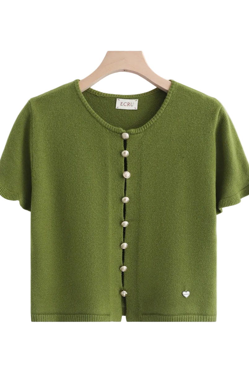An olive green short-sleeve knit cardigan sweater hanging on a wooden hanger against a white background, featuring a black button placket with buttons and a small heart detail near the lower right hem.