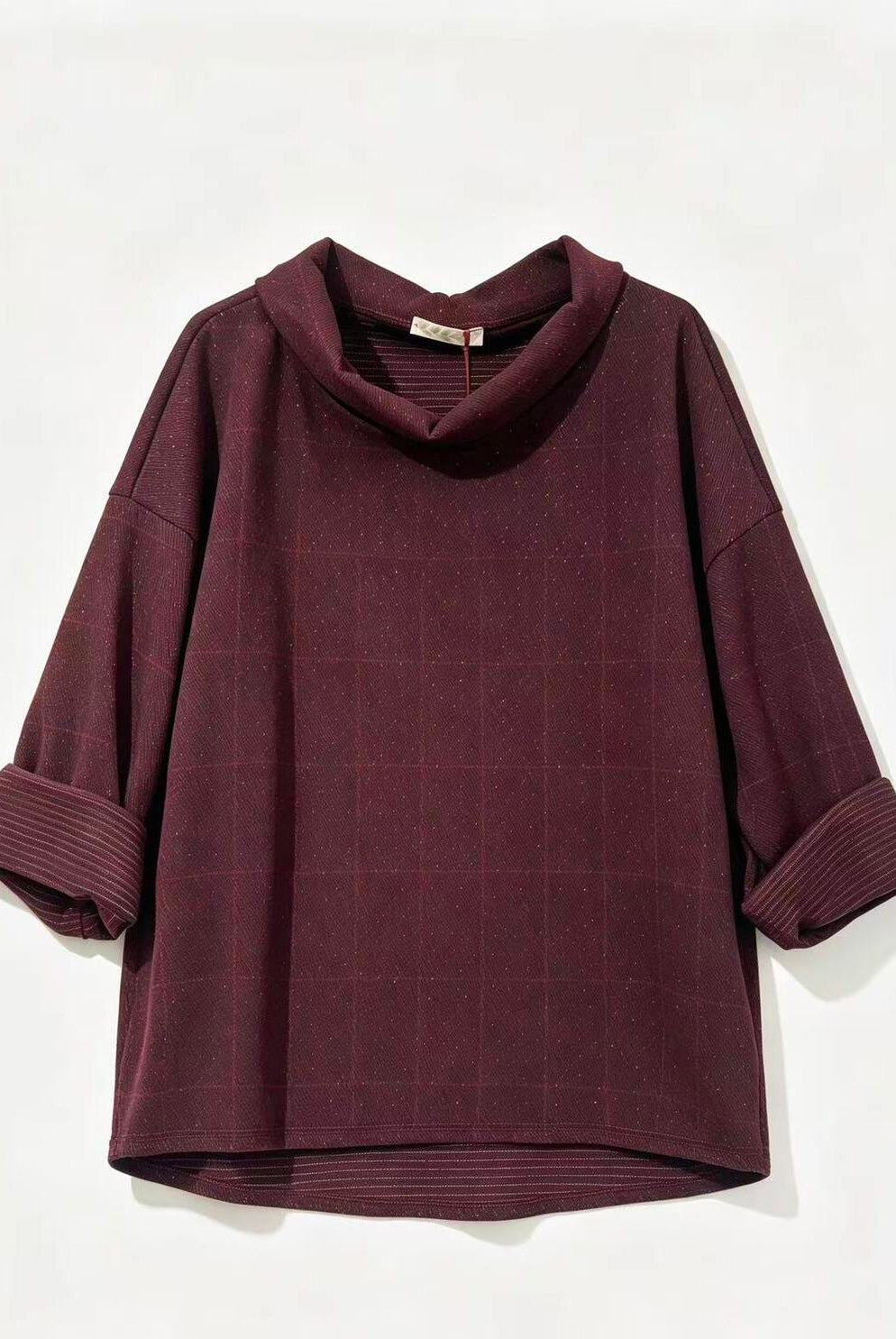 A dark burgundy cowl-neck top with a subtle grid pattern and rolled-up sleeves, displayed against a plain off-white background.
