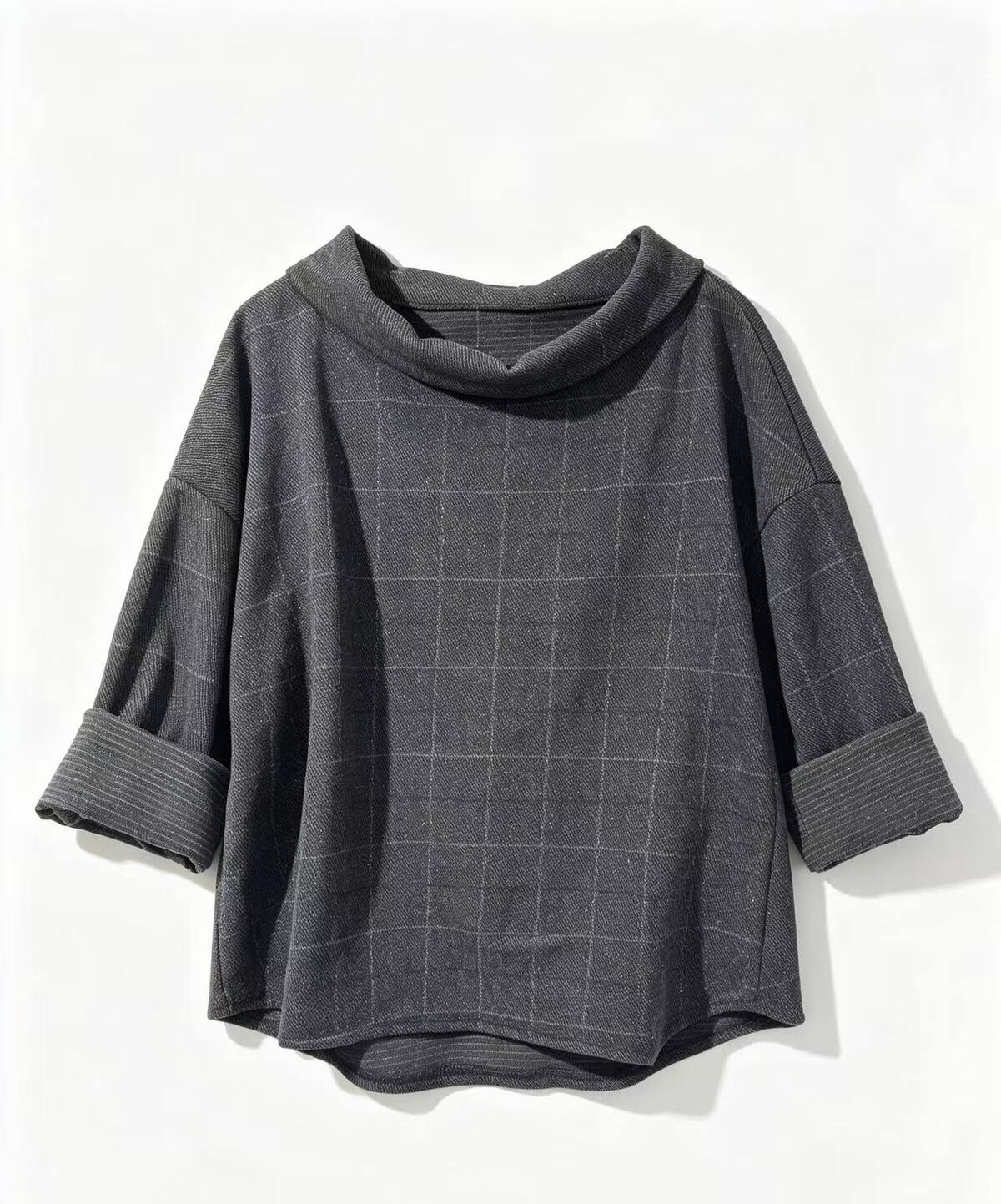 A dark grey cowl-neck top with a subtle check pattern, featuring rolled cuffs,
