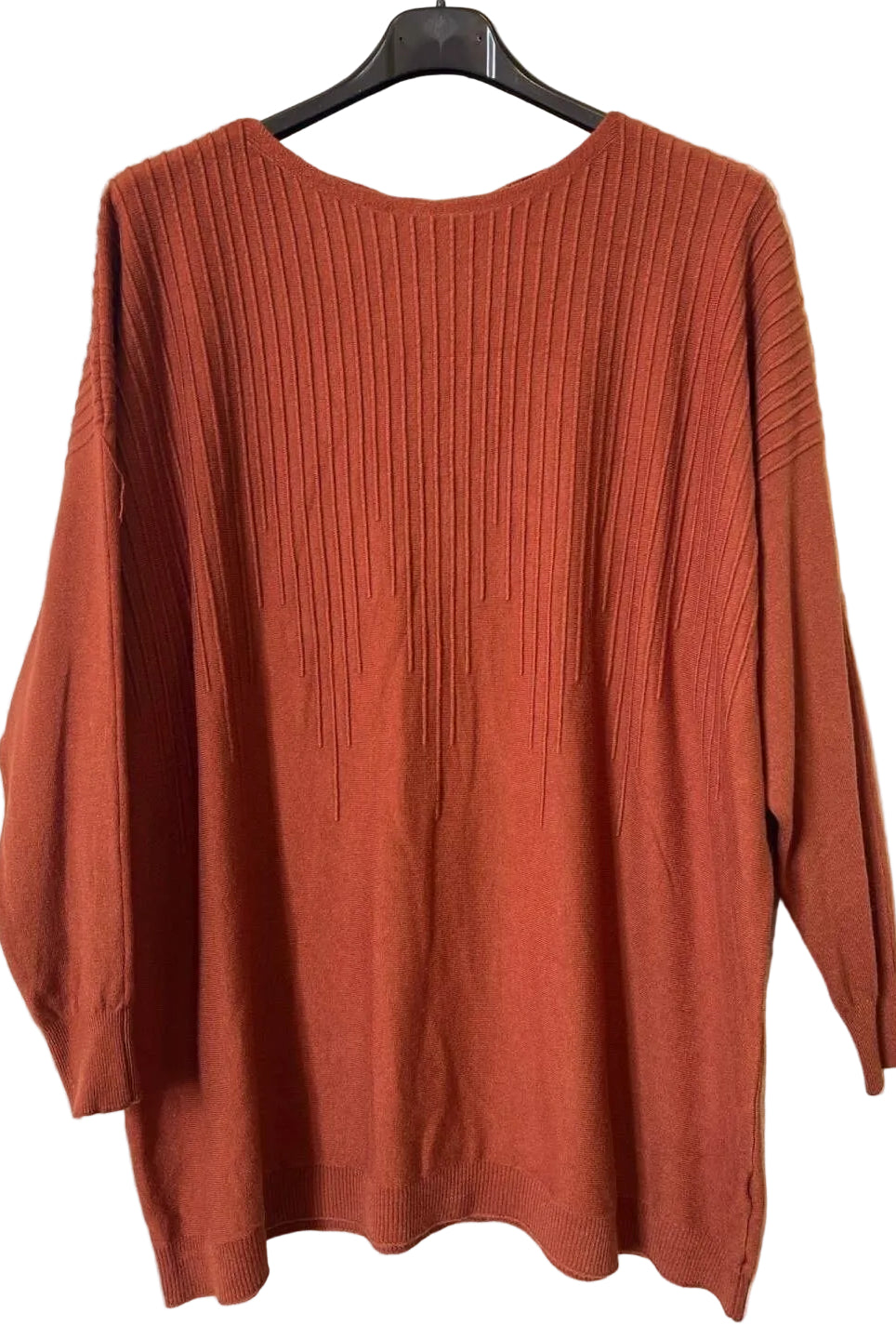 A rust-orange ribbed knit sweater