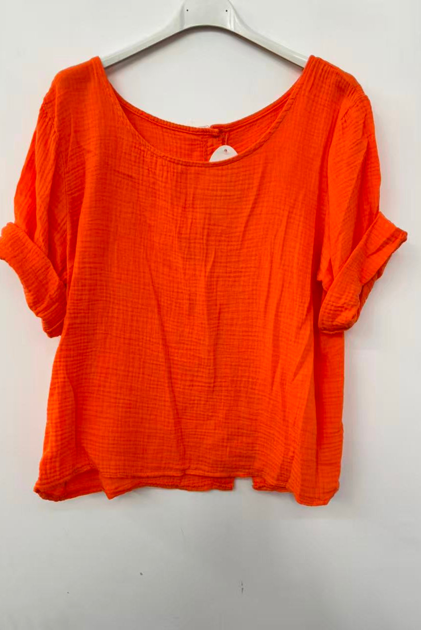 Orange shirt on a hanger against a white background