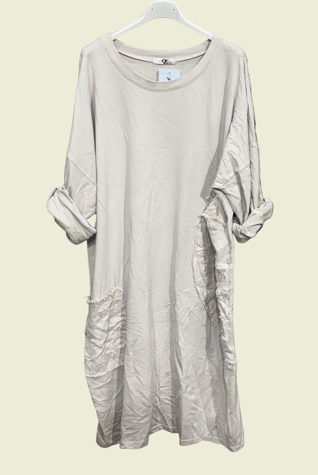 Ecru dress on a hanger
