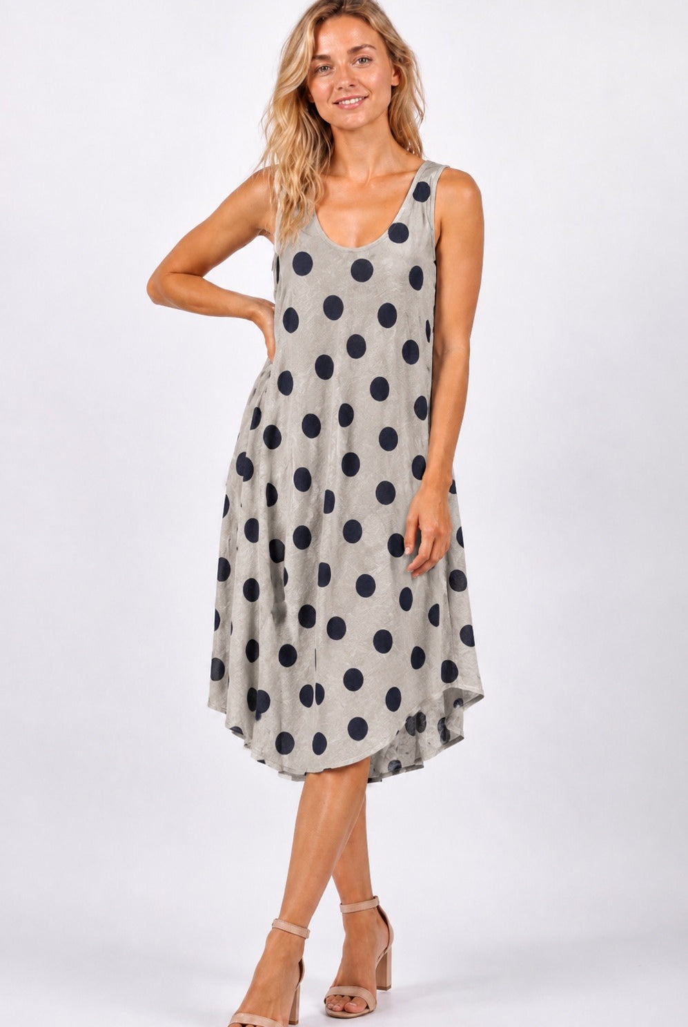 Woman wearing a polka dot dress on a white background
