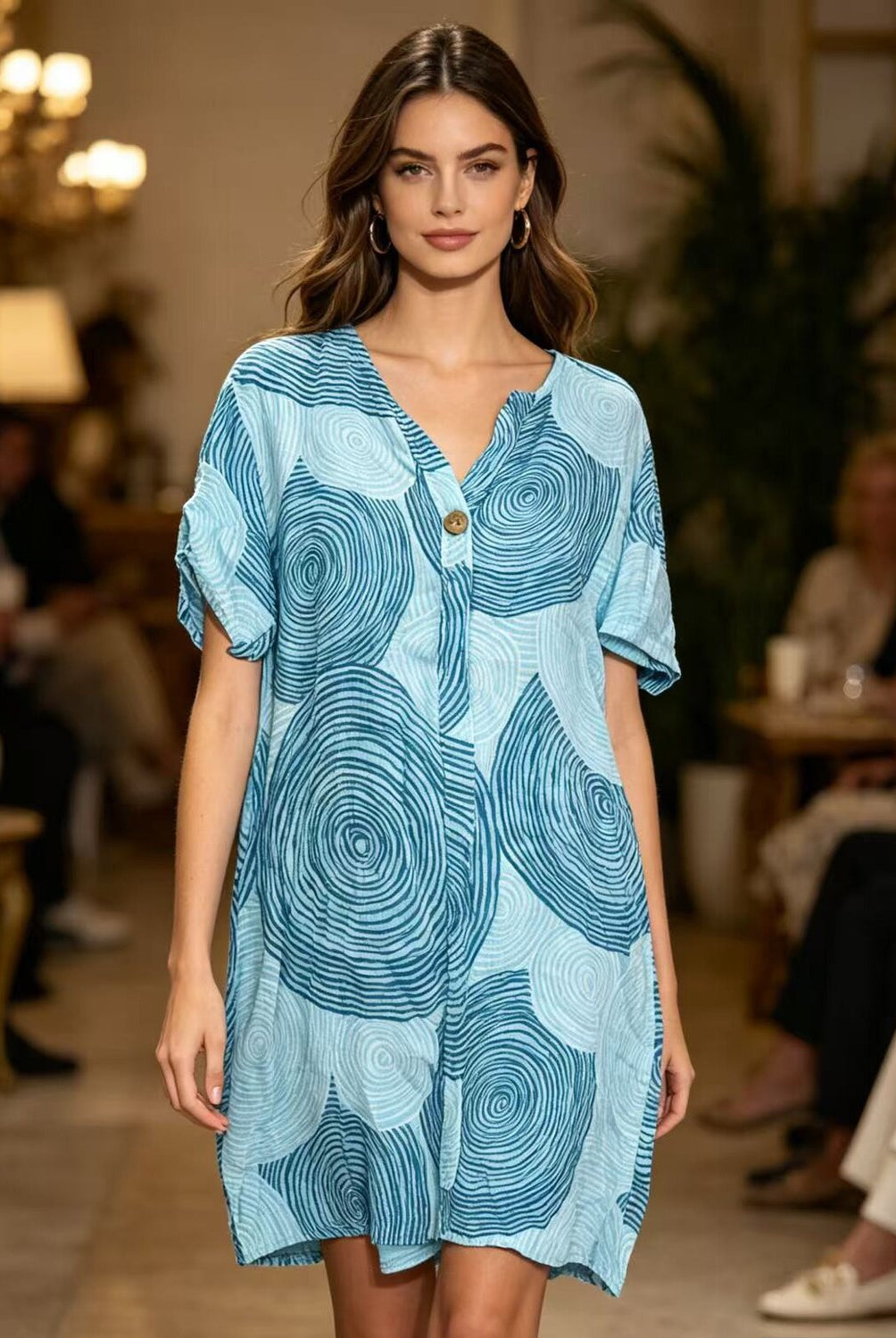 Woman wearing a blue patterned dress at an event