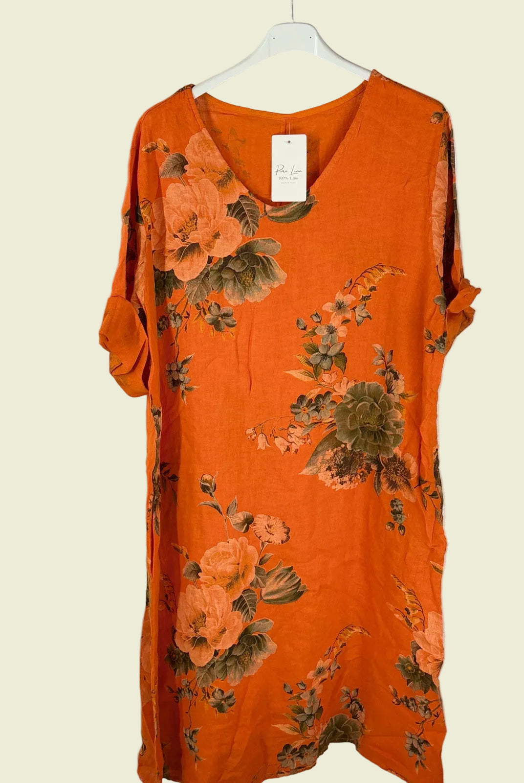 Orange floral dress on a white hanger