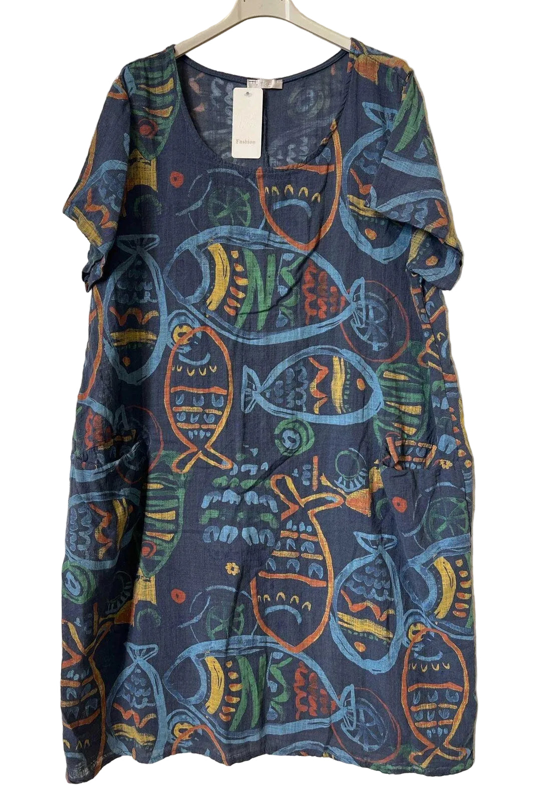 A short-sleeve V-neck dress with a colorful fish pattern on a dark blue base, hanging on a white hanger against a textured gray background.