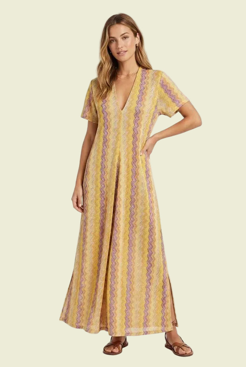 Woman wearing a yellow patterned dress on a white background