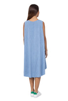 Woman wearing a light blue sleeveless dress on a white background