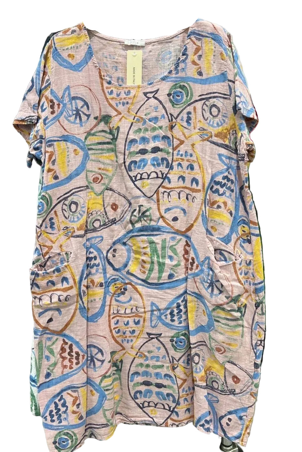A short-sleeve tunic dress with a colorful fish pattern on a light pink base,