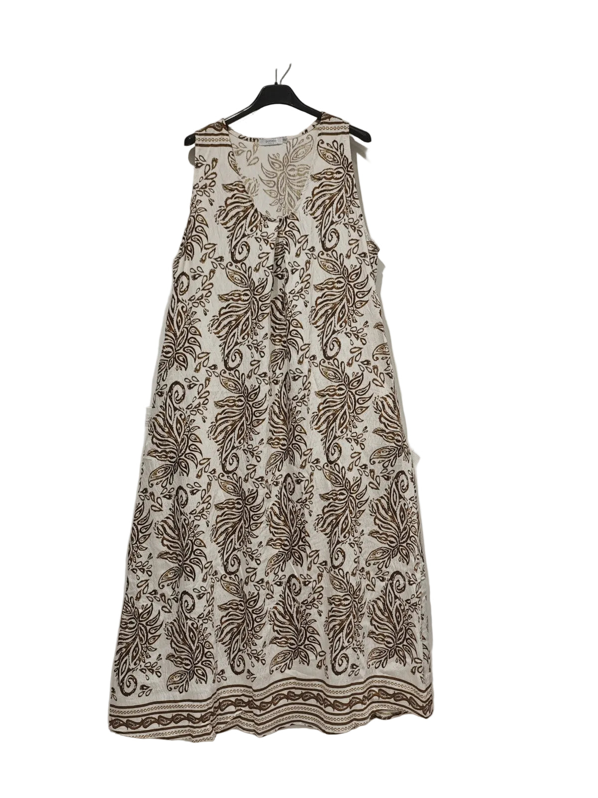 Floral patterned dress on a hanger against a plain background