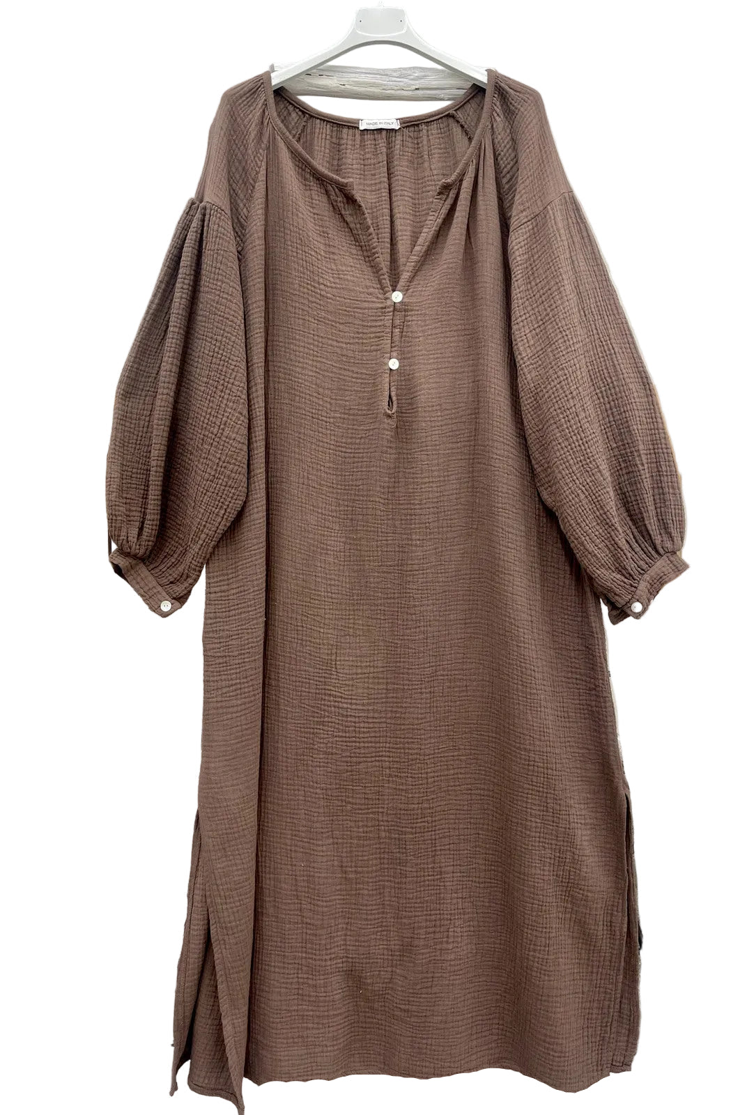 A brown textured midi dress with balloon sleeves and a tassel tie neckline,