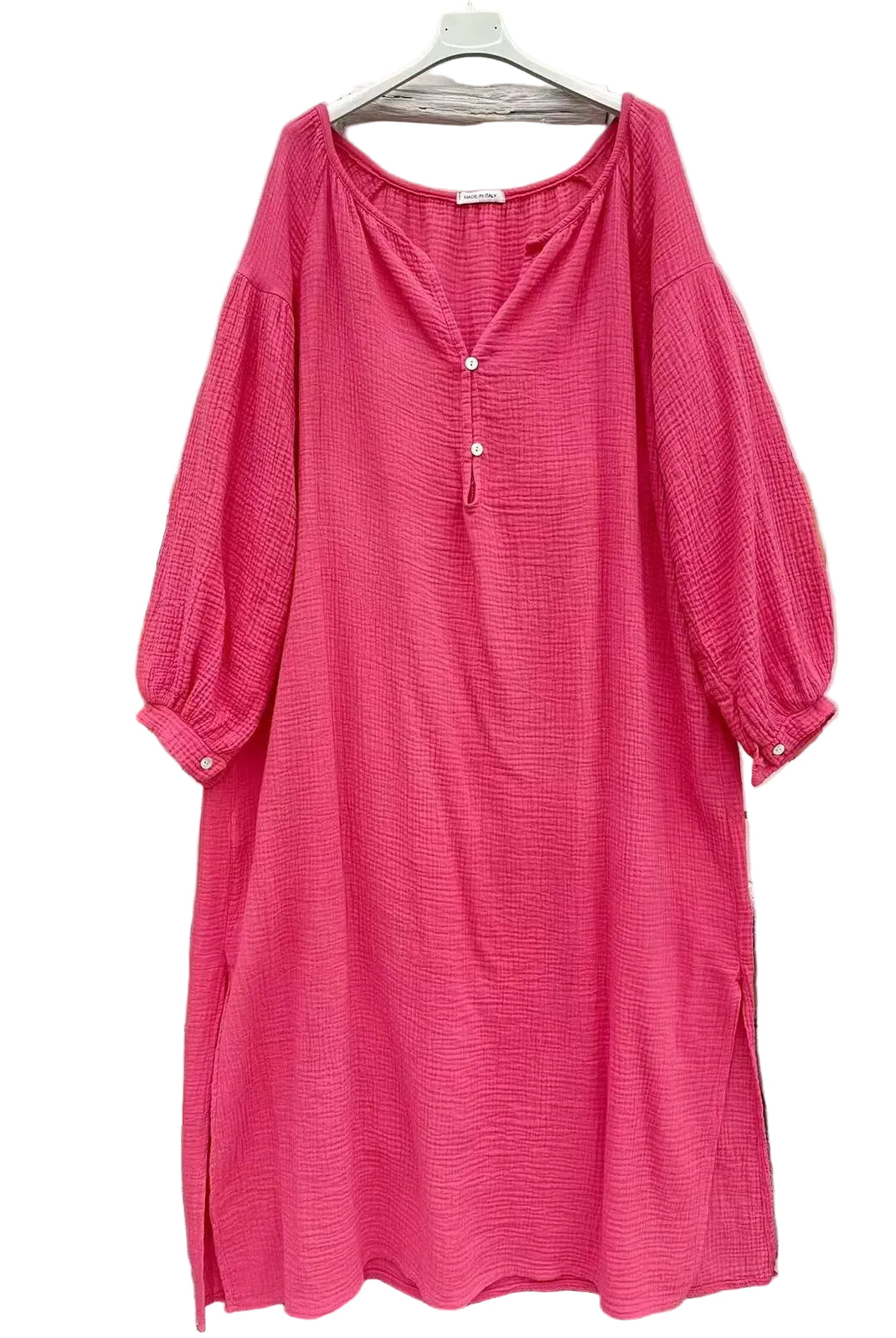 A bright pink textured cotton dress with a split neckline, three-quarter balloon sleeves,