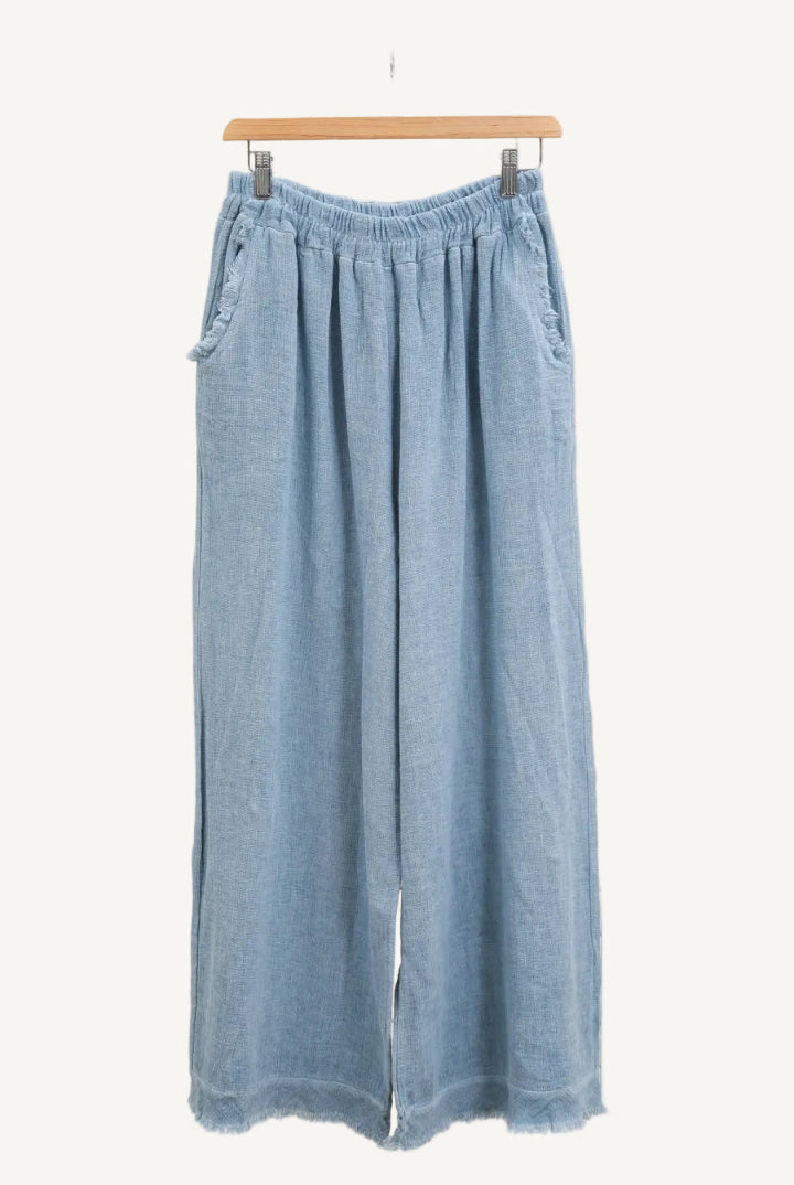 Sky blue denim wide-leg pants on a hanger against a white background