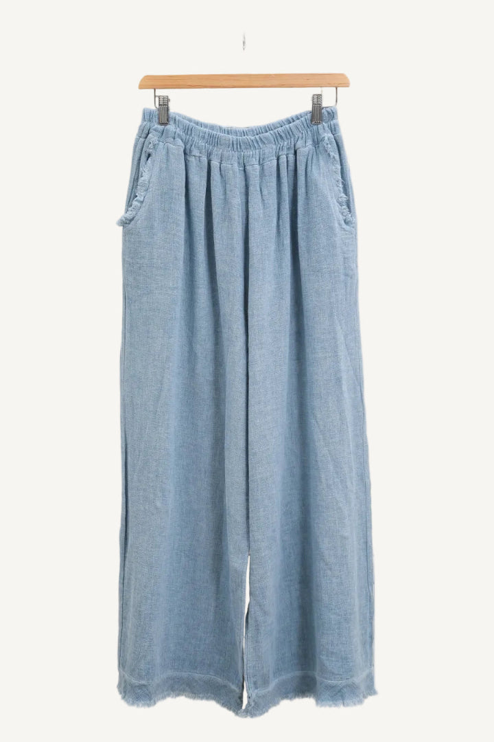 Sky blue denim wide-leg pants on a hanger against a white background