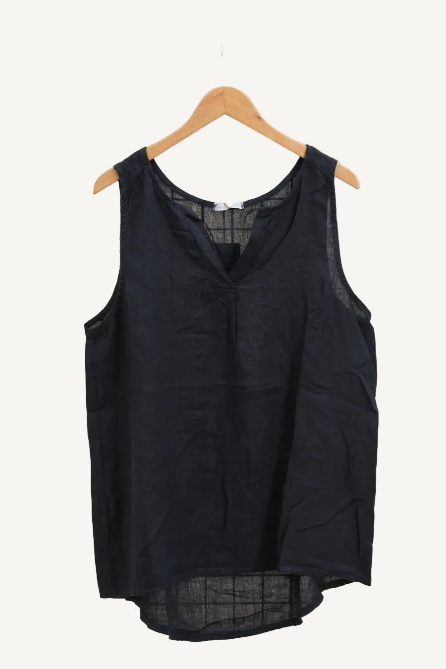 Navy blue sleeveless top on a wooden hanger