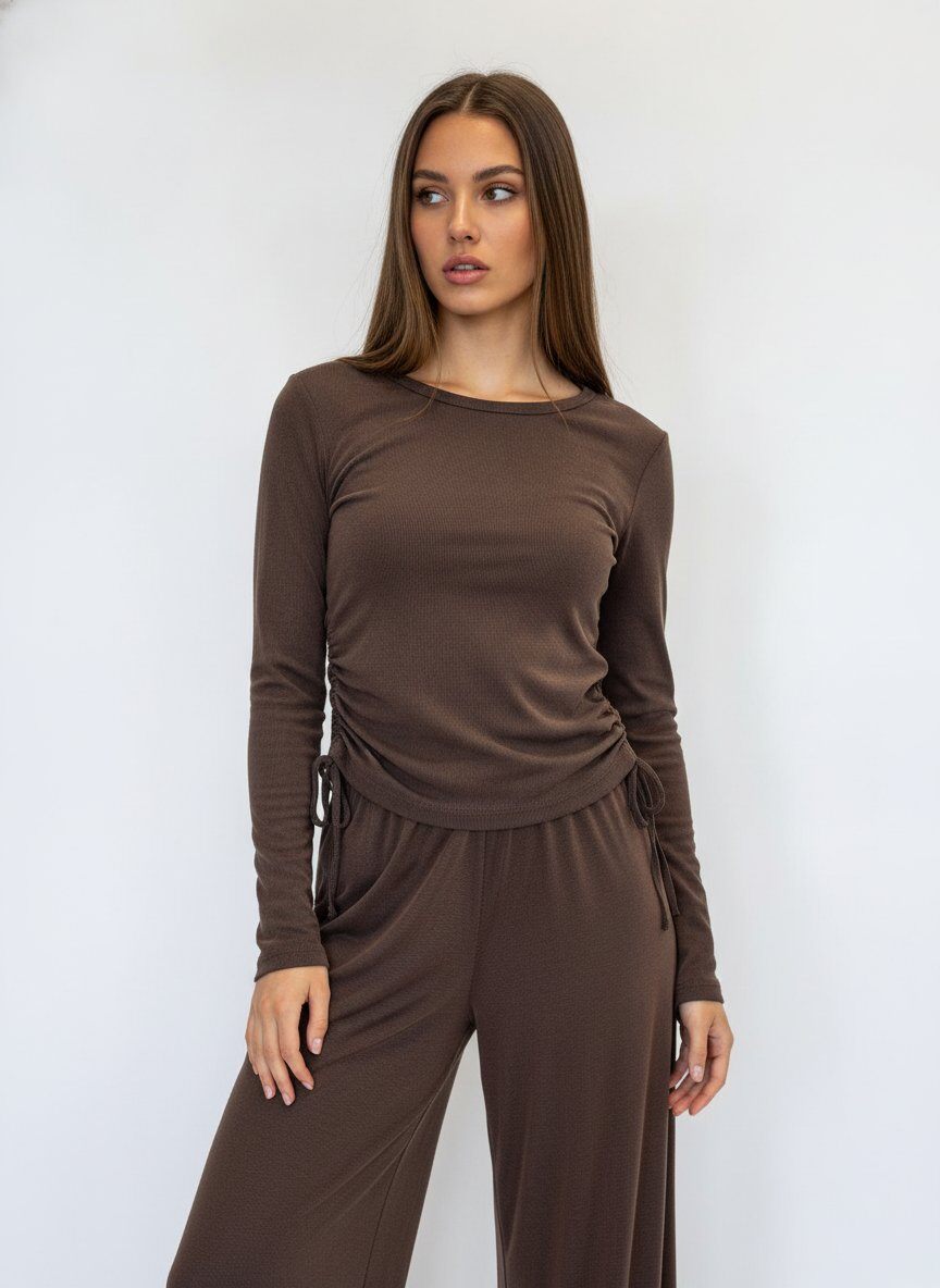 A woman modeling a matching brown long-sleeve top and wide-leg pants set