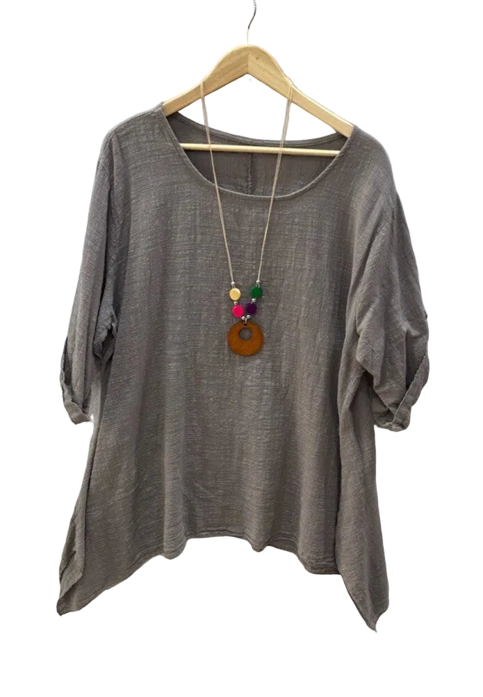 A taupe brown cotton top with three-quarter sleeves hanging on a wooden hanger