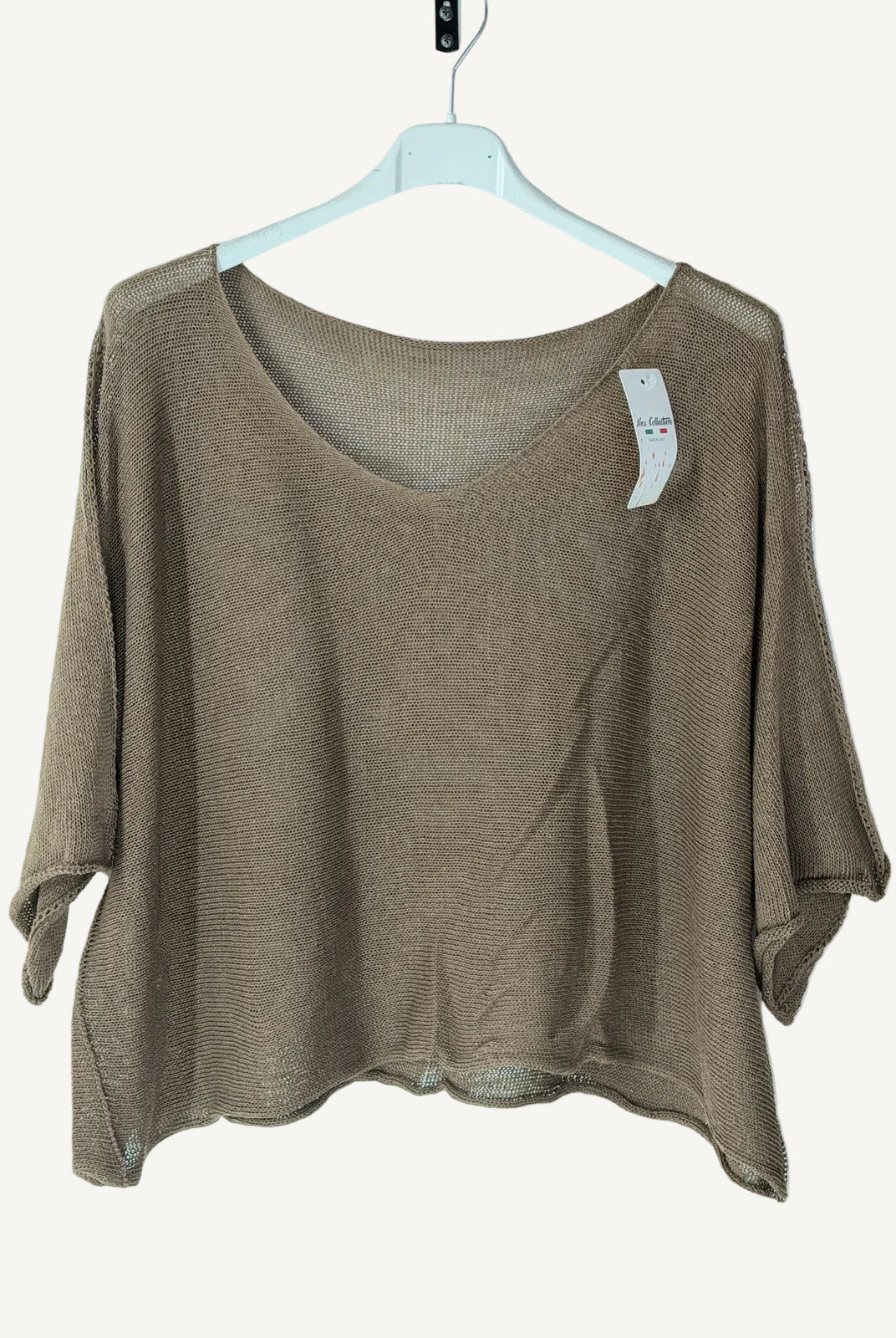 Brown knit top on a hanger against a white background