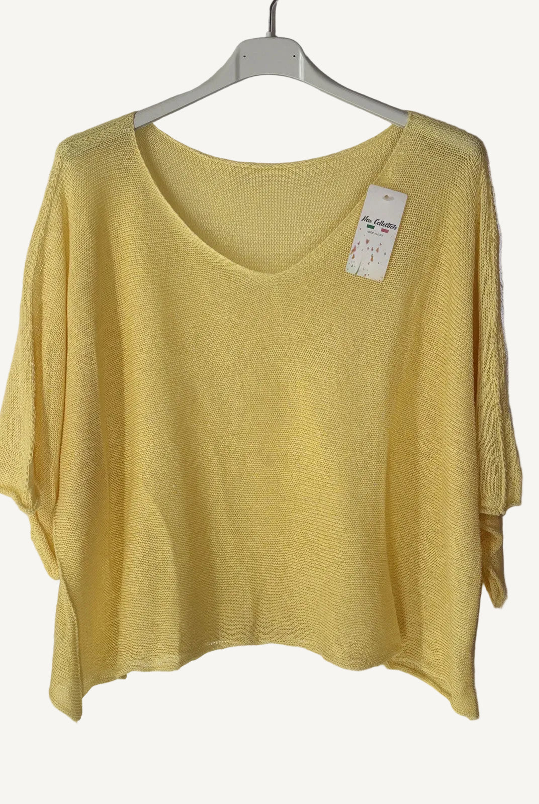 Yellow sweater on a hanger with a v neck