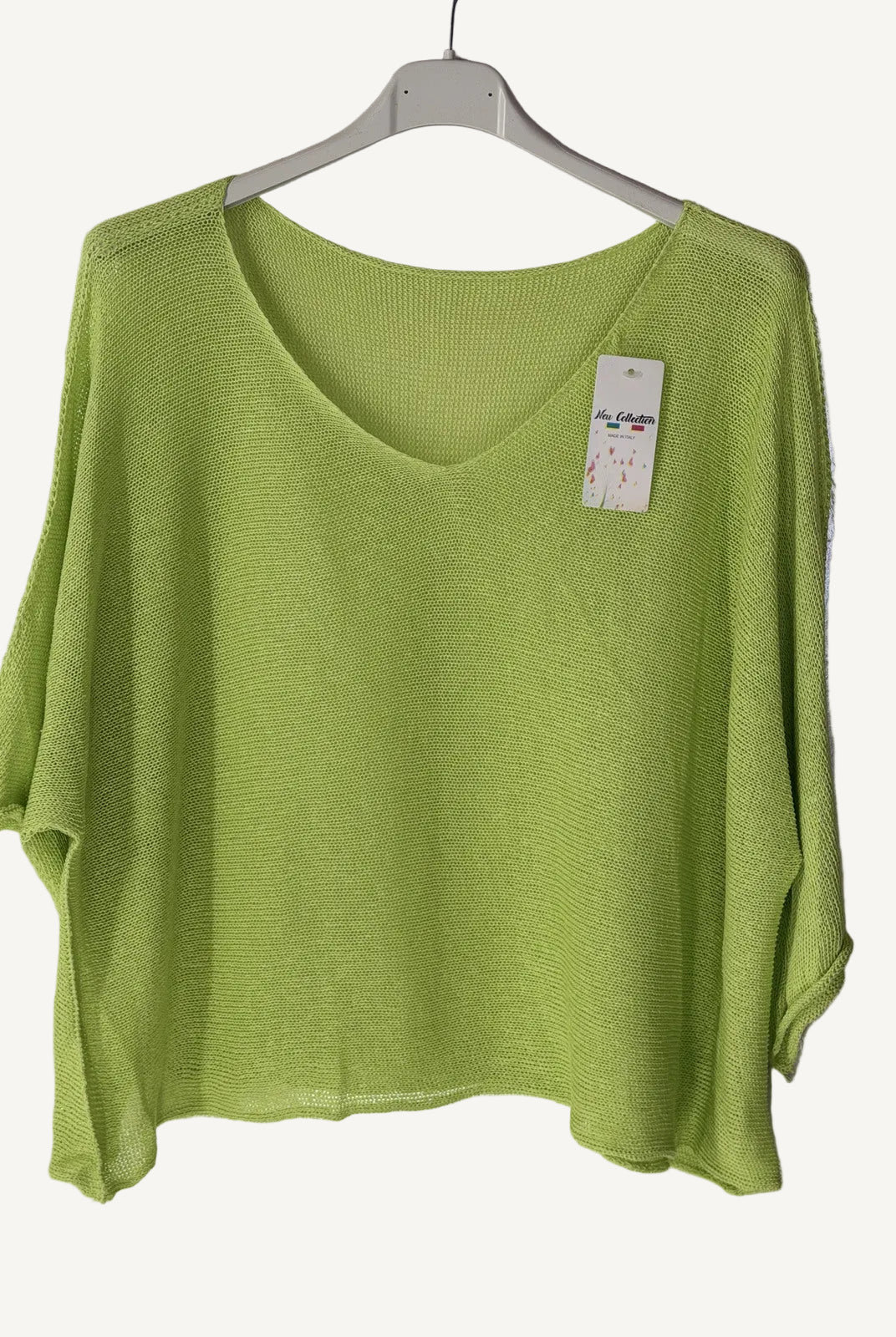 Green sweater with a v neck on a hanger