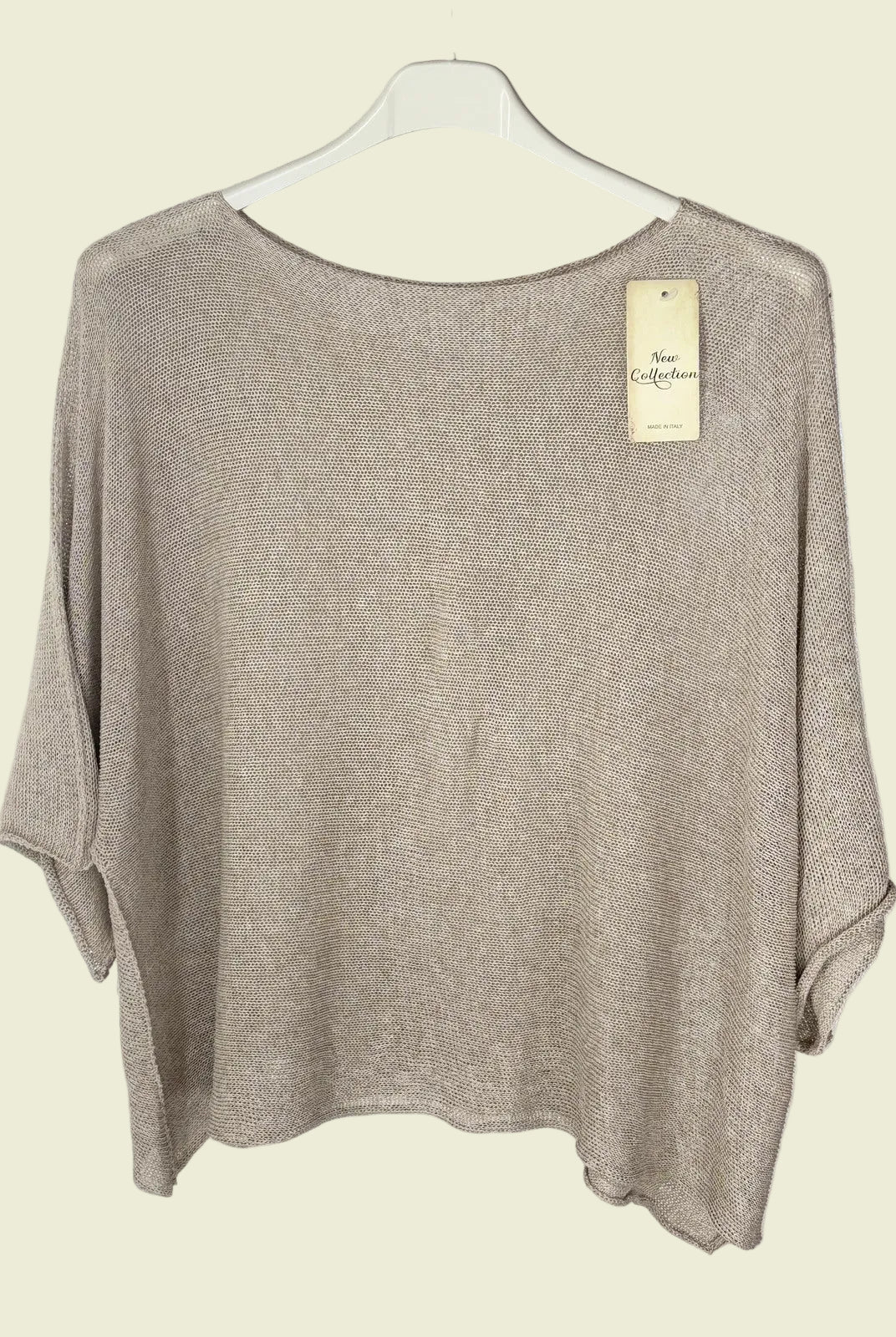 Beige sweater on a hanger