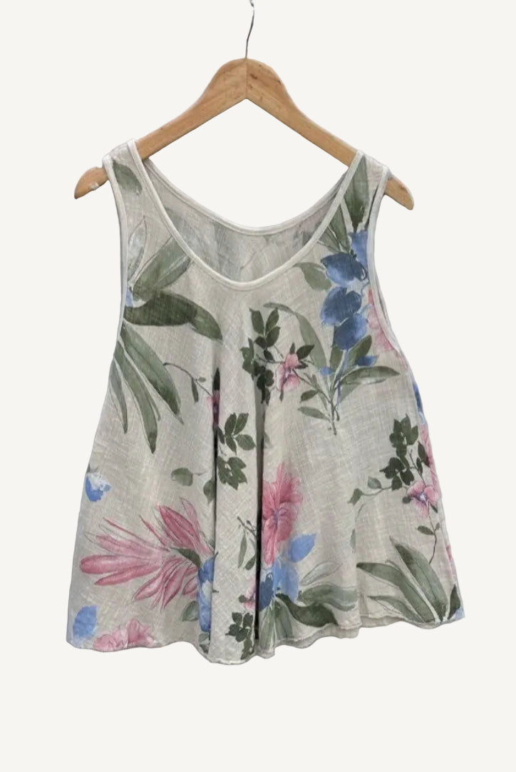 Floral-patterned sleeveless top on a hanger against a textured white background